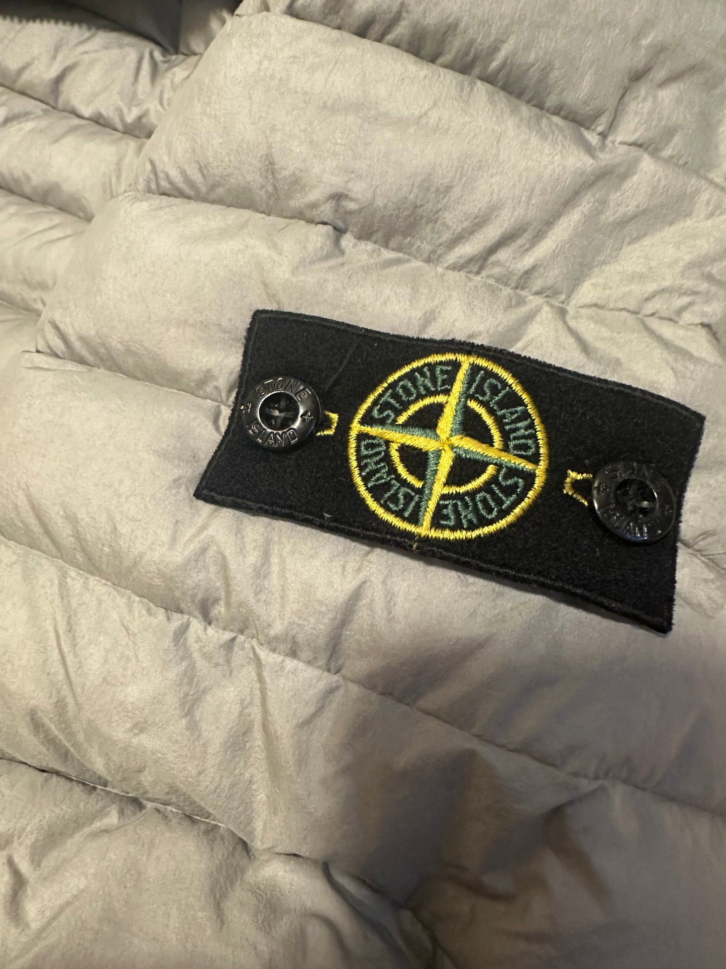 Stone Island down jacket pocket and hem detail — FashnLuxe