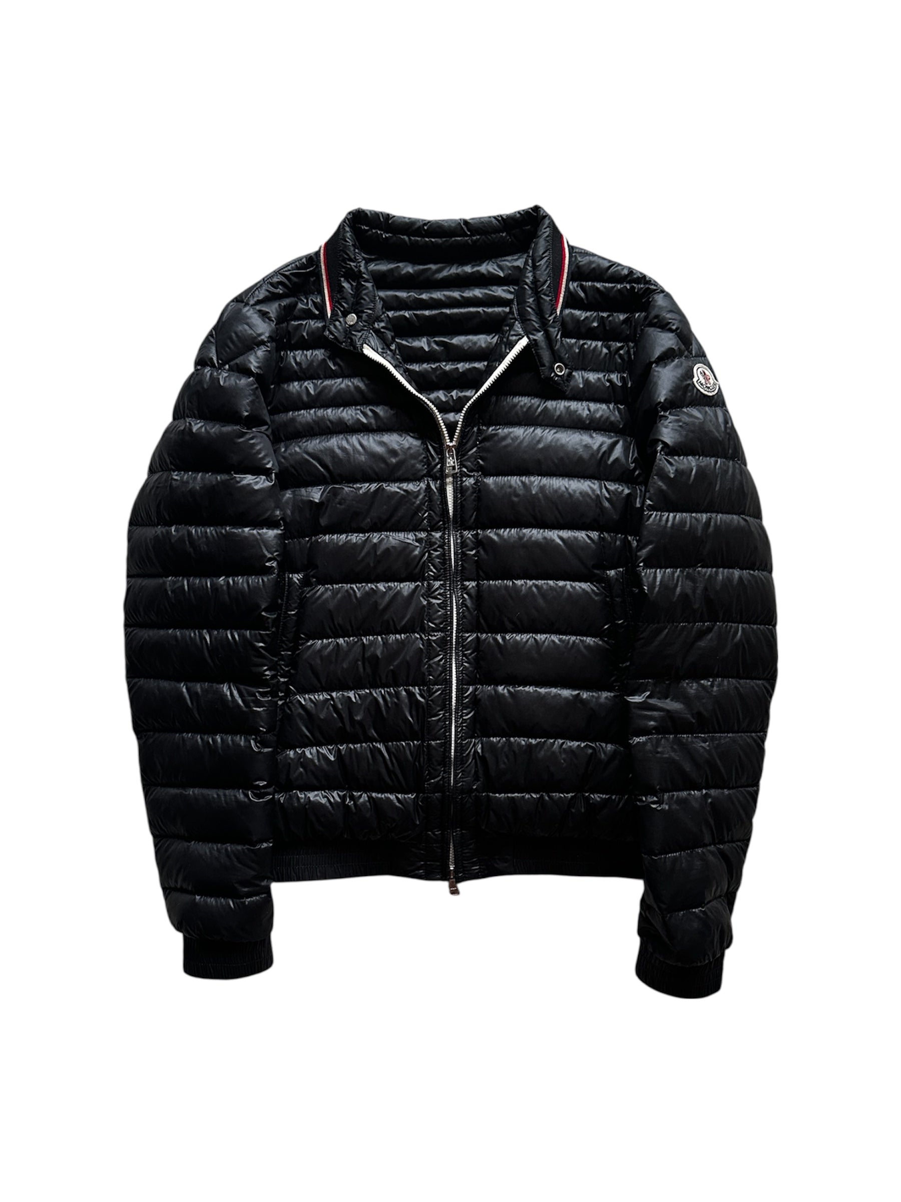 Moncler down jacket front view with tricolour badge — FashnLuxe