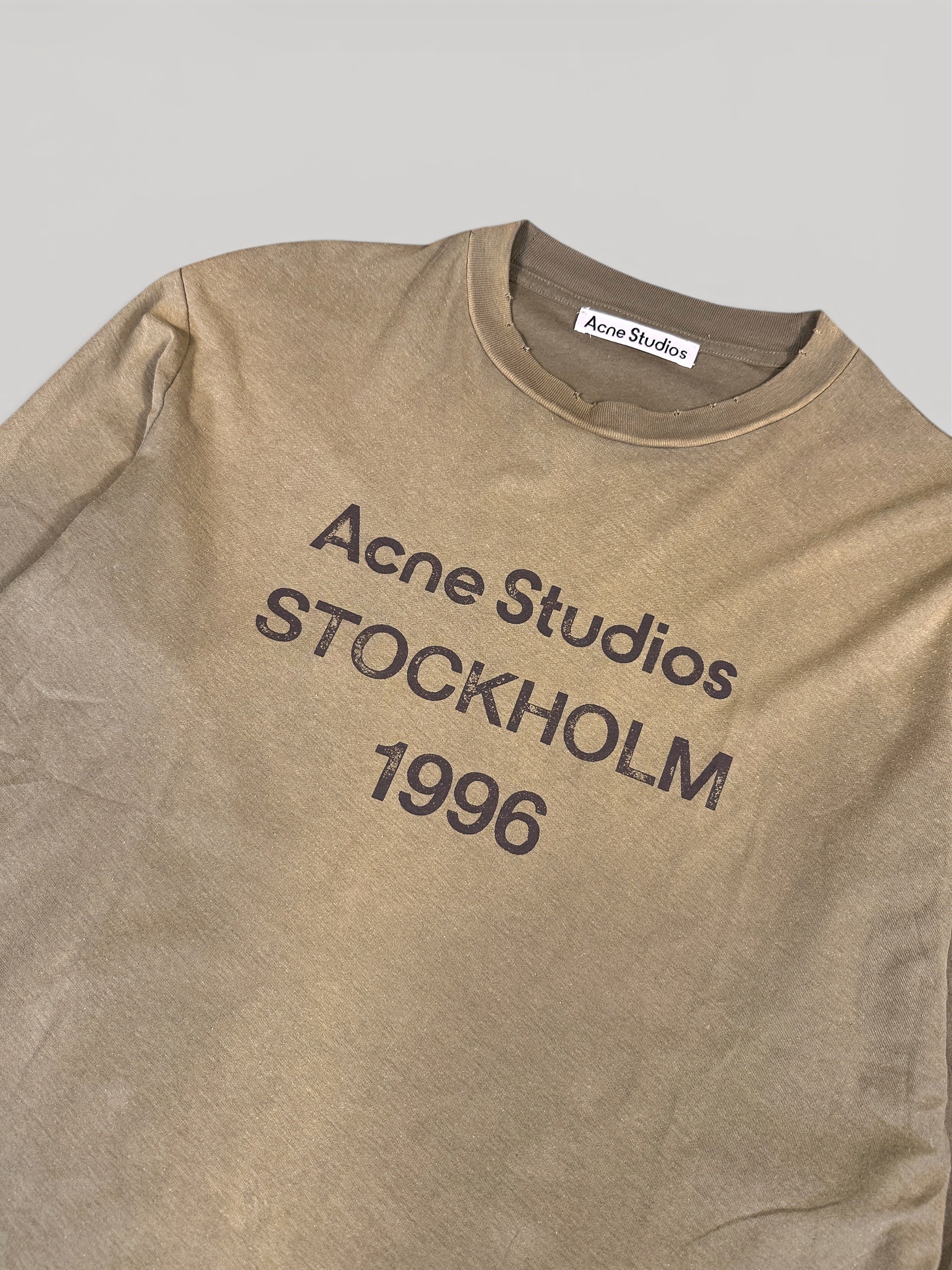 Close-up of the Acne Studios STOCKHOLM 1996 chest print and neck label