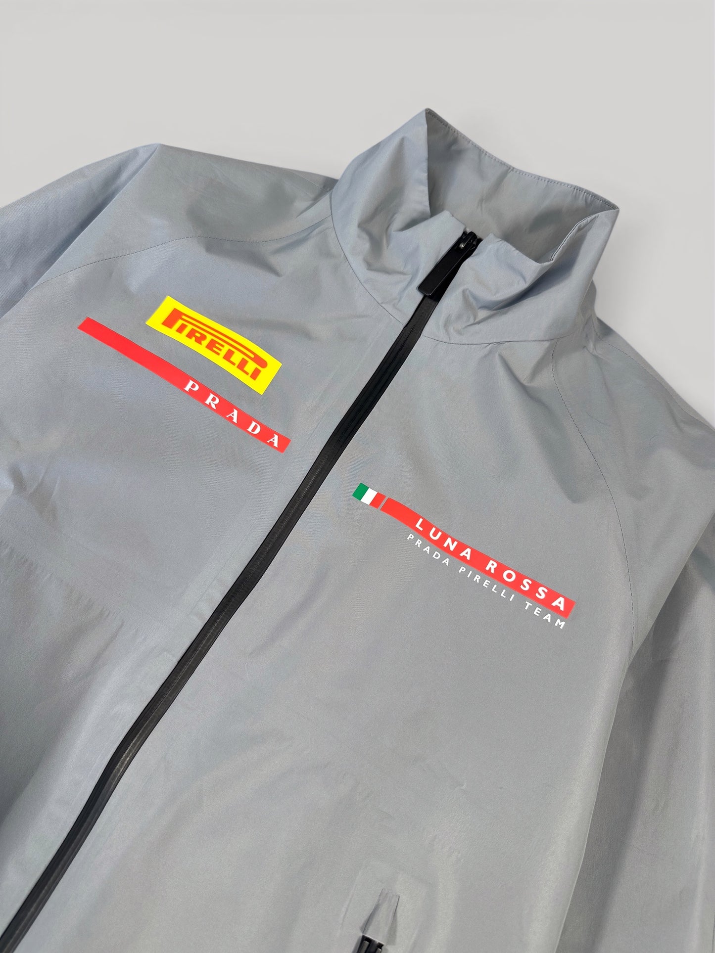 Pirelli, Prada and Luna Rossa team graphics at the chest of the Prada jacket